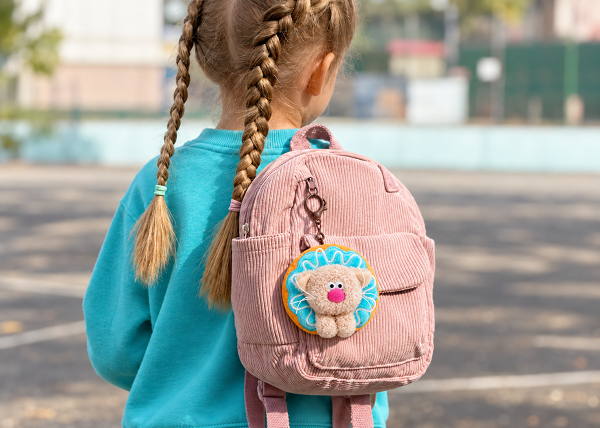 Plush cat keychain on pink backpack 2.png