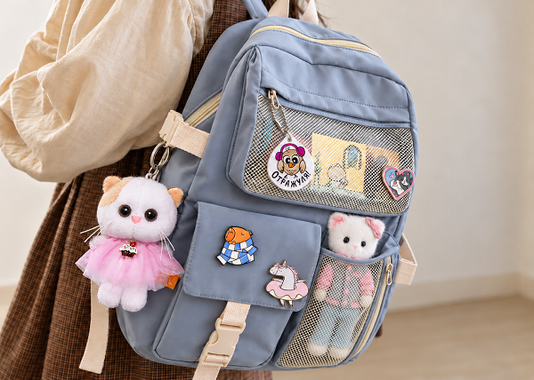 Plush cat tucked into the mesh pocket 2.png